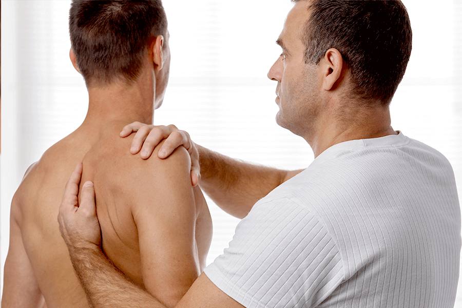 Physical therapist adjusting a man's kyphosis