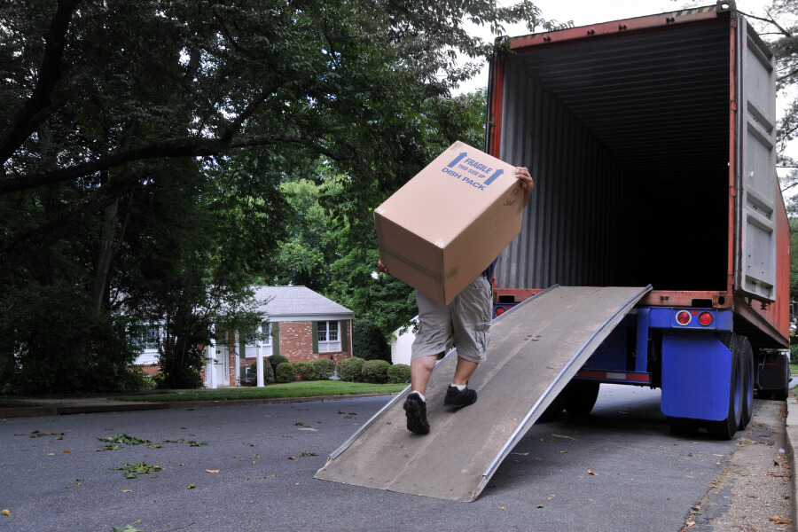 Mover carrying a heavy box on his back