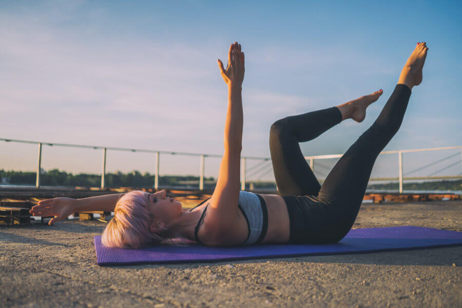 Woman in a dead bug pose