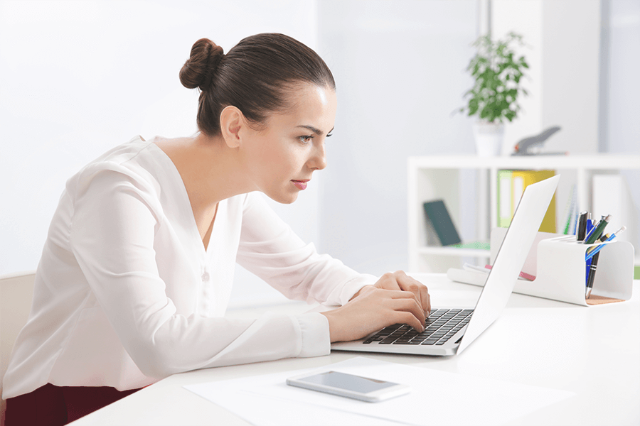 Woman with poor posture working on her laptop