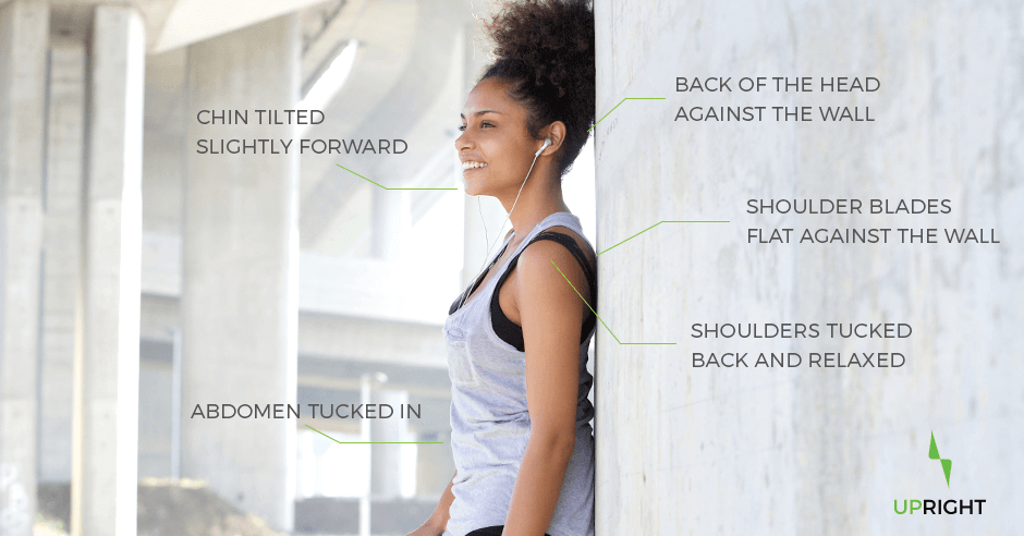 Woman standing against a wall demonstrating how to have good posture