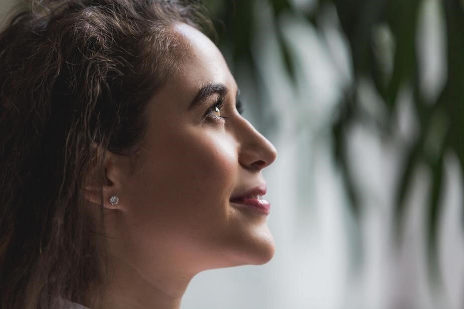 Woman smiling up to the sky with gratitude