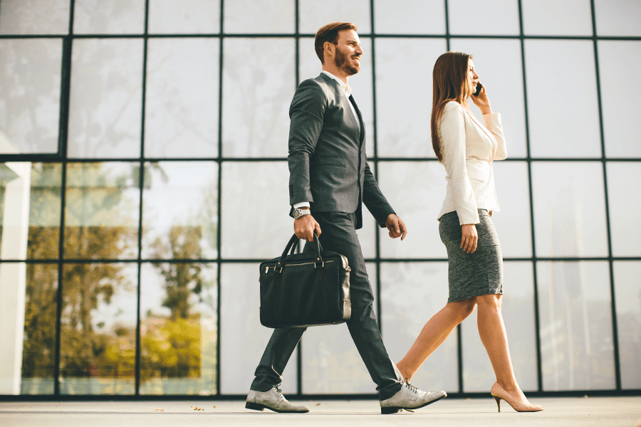 Man and woman with good posture walking in an office building