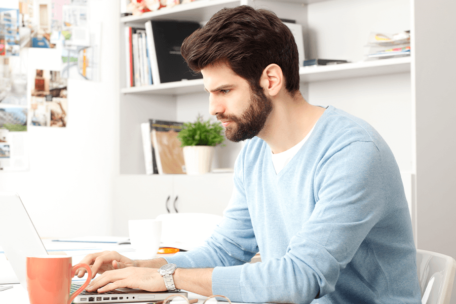 Man with good posture working on his laptop