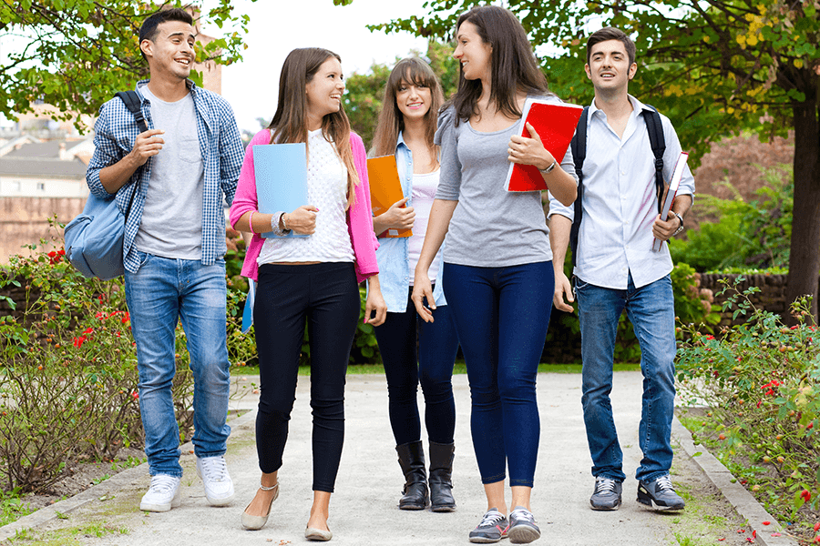 Five college students with good posture walking and talking