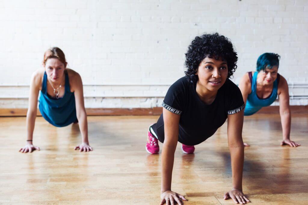 Three people exercising their core muscles to improve back posture