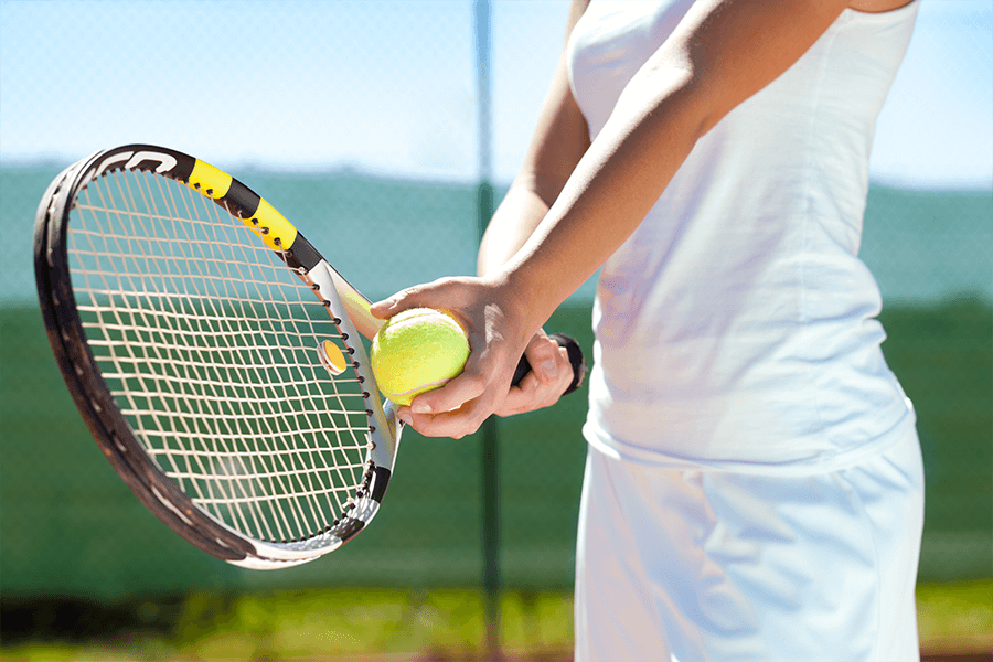 Tennis player getting ready to serve the ball