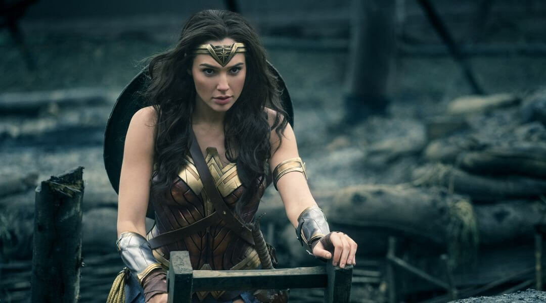 Gal Gadot as Wonder Woman climbing out of a trench